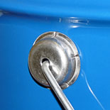 Closeup of a straight sided tinplate metal pail showing the robust handle joint